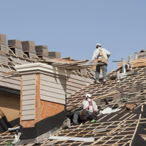roofers on top of roof storm damage repair lafayette la